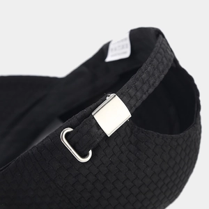 Detail of waffle textured baseball cap featuring adjustable silver buckle and inner label