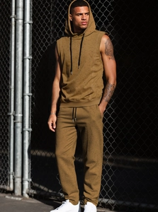 Outdoor shot of men's sleeveless hoodie and jogger pants set in ginger brown knit fabric
