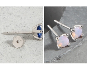 Detailed view of 925 sterling silver earrings with blue stones and white opals