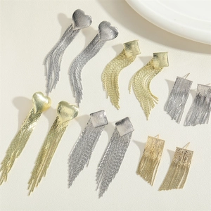 Detail of metal fringe earrings with heart and square studs in gold and silver finish