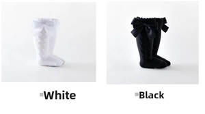 Detailed knit texture and satin bows on white and black knee high baby socks