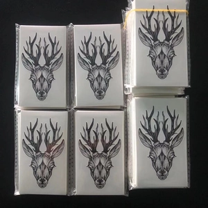 Set of 32 temporary tattoo stickers with black and white deer head patterns in packaging