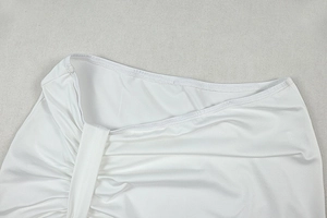 Detailed view of the white ruched waist design on this two-piece skirt set fabric