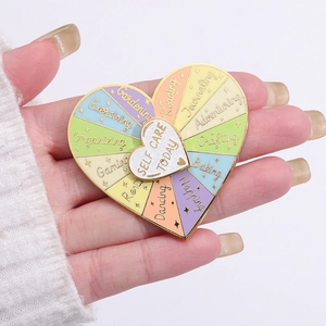 Rotating heart enamel pin for self care routines with golden border and colorful sections