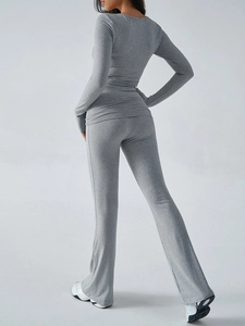 Rear view of a grey slim fit knitted long sleeve top and pants set for women