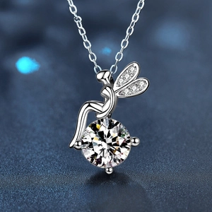 Macro detail of silver fairy pendant with sparkling moissanite and engraved True Love Forever