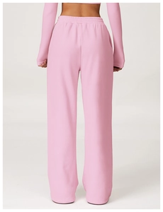 Back view of high waist pink wide-leg sweatpants and long sleeve crop top in studio