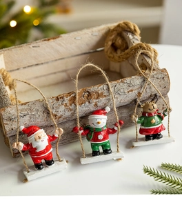 Detailed view of resin Santa, Snowman, and Reindeer figurines on rope swings for Christmas
