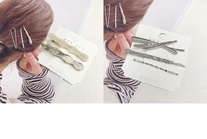 Detailed view of alloy hair clips with resin amber patterns and delicate mini pearls