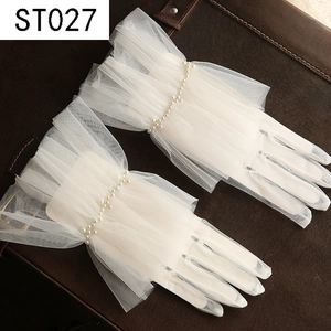 Detailed close-up of white tulle wedding gloves featuring elegant pearl wrist embellishments