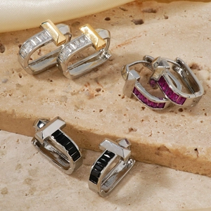 Elegant U-shaped gold and silver earrings with colorful zircon stones in geometric design