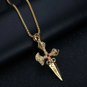 Golden Vajra pestle necklace with red gemstone and Tibetan carvings on black leather