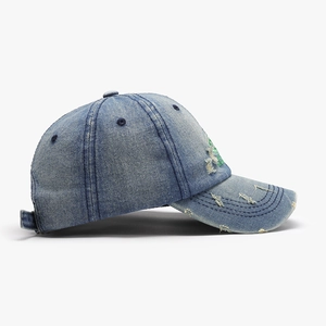 Retro washed navy denim baseball cap with green letter embroidery and distressed holes
