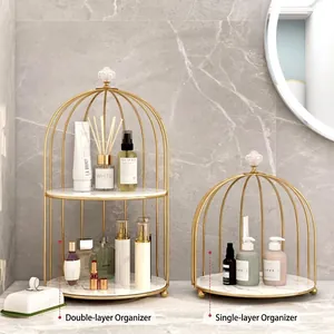 Golden birdcage-style makeup organizers in single and double tiers with marble pattern base