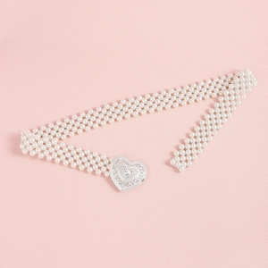 Detailed view of a white multi-strand pearl belt featuring a silver heart-shaped metal buckle