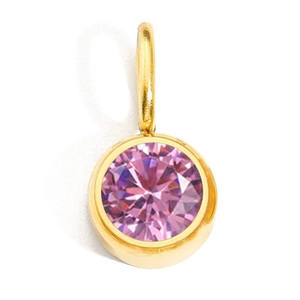 Macro view of a round pink crystal birthstone pendant with golden bezel setting