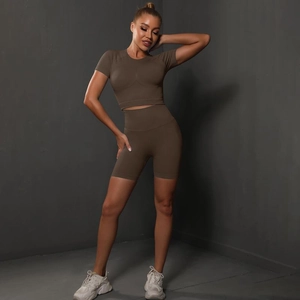 Close-up of seamless high-waist yoga shorts and crop top in ribbed olive fabric