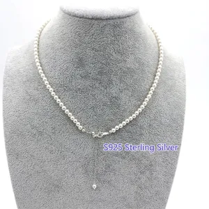 Elegant white round pearl necklace with S925 sterling silver adjustable chain on a jewelry display