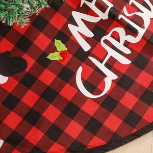 Red and black plaid Christmas tree skirt with Merry Christmas text and holly berries