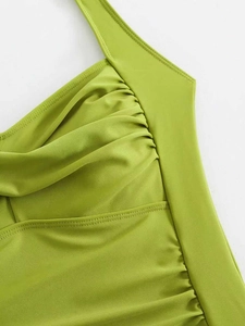 Detailed close-up of lime green swimsuit featuring ruched fabric and high-quality stitching