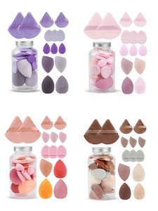 Detailed view of 14-piece makeup sponge set with various shapes in transparent jars