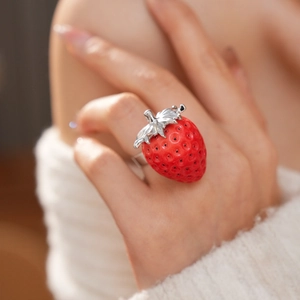 Dettaglio dell'anello a fragola in resina rossa con strass e fascia in metallo argentato