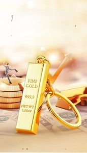 Detailed close-up of 999.9 gold bar keychain with polished finish and engraved markings