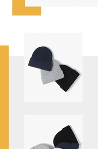 Close-up of ribbed knit texture on thermal beanies in navy blue, grey, and black
