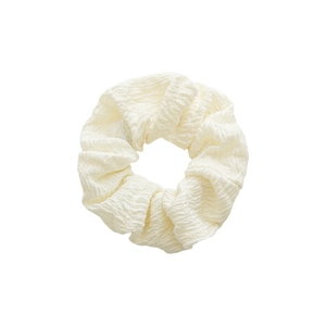 Minimalist cream polyester scrunchie with pleated texture on a clean white background