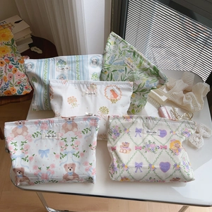 Detailed collection of floral and printed cotton makeup bags with top zipper closure