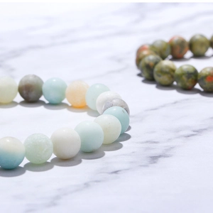 Macro shot of natural volcanic stone beaded bracelets with blue and white marble texture