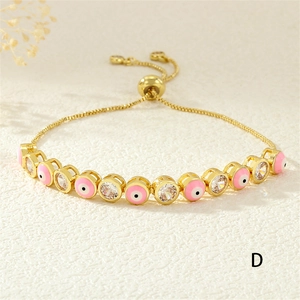 Detail of pink enamel evil eye bracelet with adjustable sliding bolo clasp and gold plating