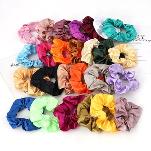 Colorful satin silk scrunchies in various vibrant solid colors for hair styling