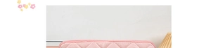 Detailed close-up of pink quilted fabric texture and zipper on the soft storage bag