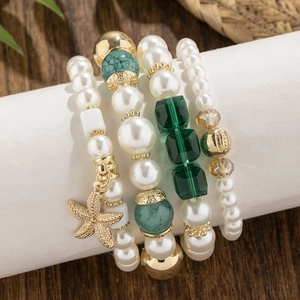 Bohemian multi-layer faux pearl beaded bracelet featuring green crystal and gold starfish charm