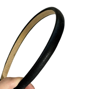 Black vintage thin headband with fine shimmer fabric and beige lining on white background