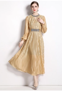 Macro view of champagne pleated dress featuring heavy beaded waist and neckline detail