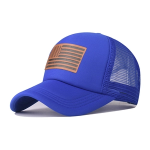 Detail of navy trucker hat with mesh back and leather patch featuring US flag design