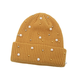 Women's mustard yellow ribbed knit beanie with elegant white pearls and metal beads