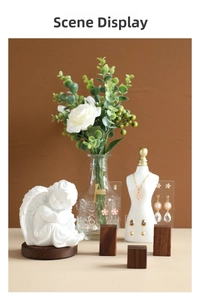 Elegant jewelry display showing floral earrings and pearl pendants on artistic stands