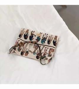 Detail of canvas tote bag featuring wooden bead handles and a colorful pharaoh jacquard print