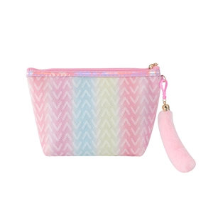Detailed view of rainbow gradient makeup bag with pink zipper and fluffy pom tail charm