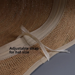 Close-up of internal adjustable drawstring on minimalist raffia straw bucket hat