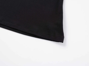Macro detail of double-needle stitching on the hem of a black fitted V-neck cotton T-shirt