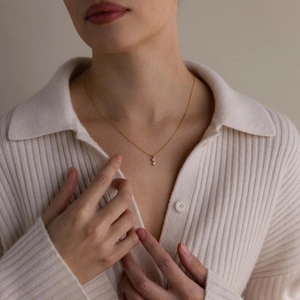 Golden titanium steel necklace featuring elegant pearl and zircon birthstone pendants