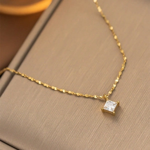 Macro shot of the square zircon pendant and 18K gold plated chain with four-prong setting