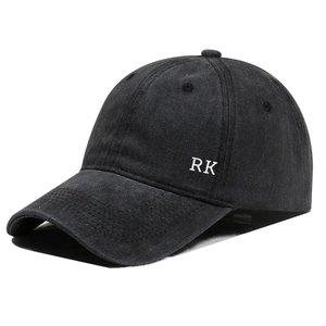 Detail view of the side RK letter embroidery on washed black cotton baseball cap