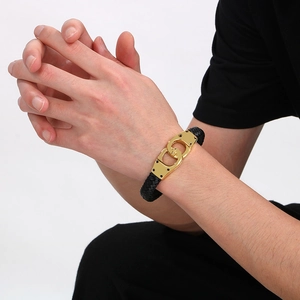 Close-up of black braided leather bracelet with gold-plated titanium steel interlocking buckle