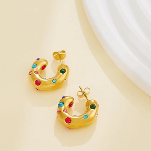 Golden C-shaped hoop earrings with colorful zircon stones shown from a 45-degree angle