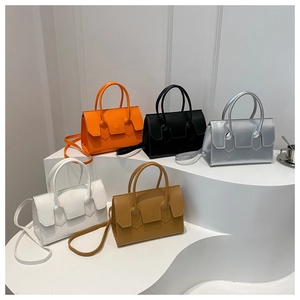Minimalist PU leather handbags in multiple colors displayed on white geometric stands